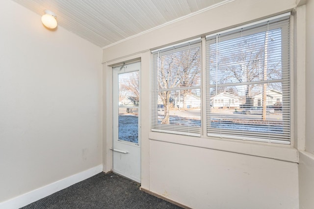 doorway featuring dark carpet