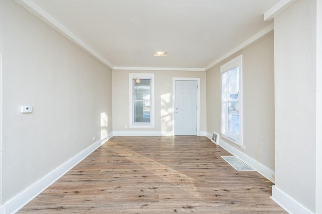 entrance foyer featuring light wood-type flooring and crown molding