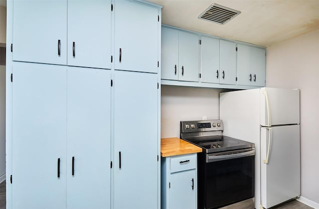 kitchen featuring white refrigerator and stainless steel electric range oven