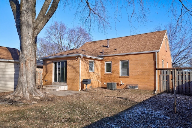 rear view of property featuring central AC