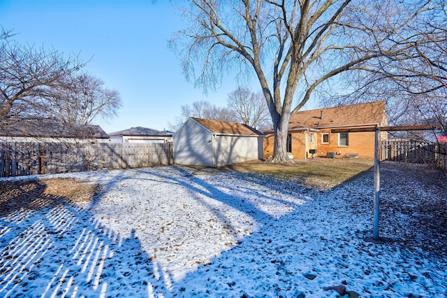 yard covered in snow with an outdoor structure