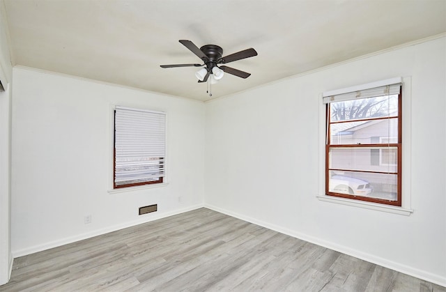 spare room featuring ceiling fan, light hardwood / wood-style floors, and ornamental molding