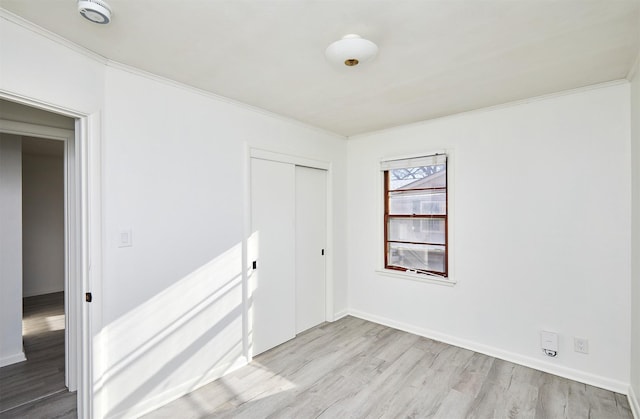 unfurnished room with light hardwood / wood-style floors and ornamental molding