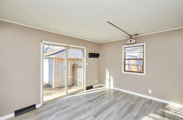 empty room featuring light hardwood / wood-style floors and ornamental molding