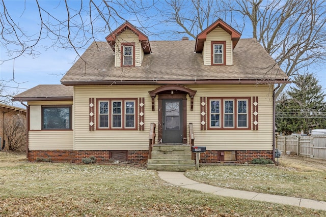 new england style home featuring a front yard