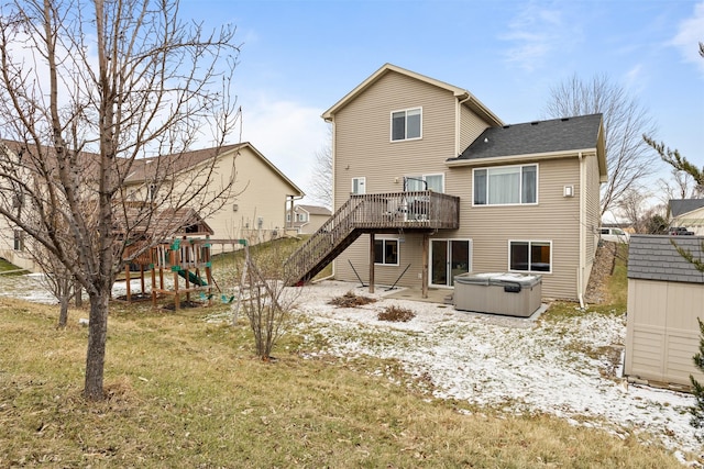 back of house with a wooden deck and a hot tub