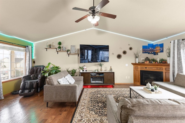 living room with hardwood / wood-style flooring, ceiling fan, and lofted ceiling