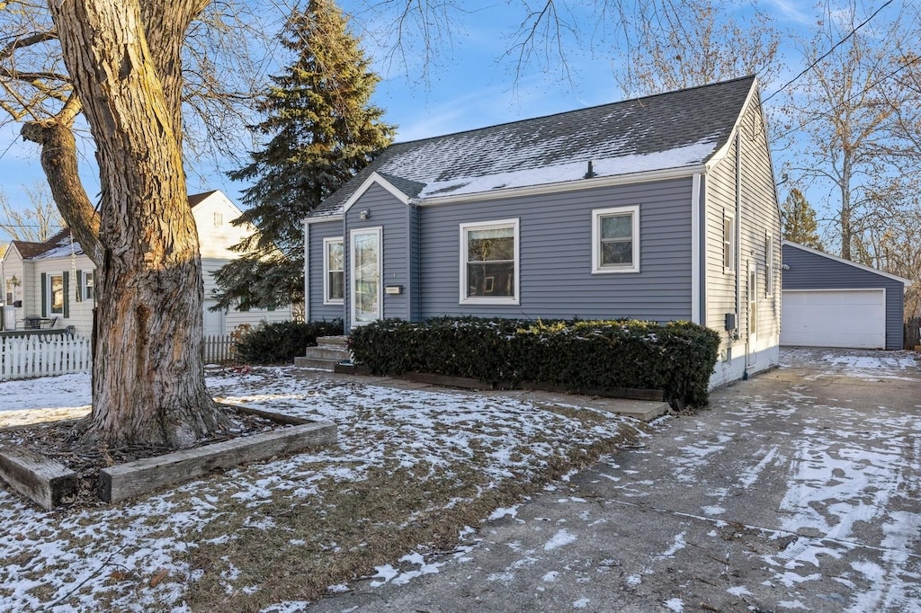 view of front facade featuring a garage and an outdoor structure