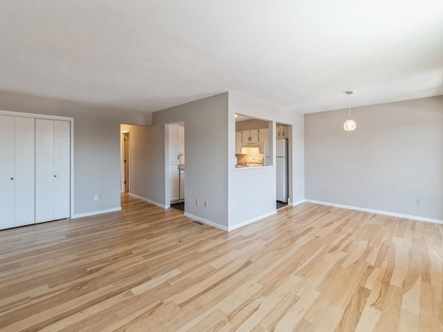 unfurnished living room featuring light wood-type flooring