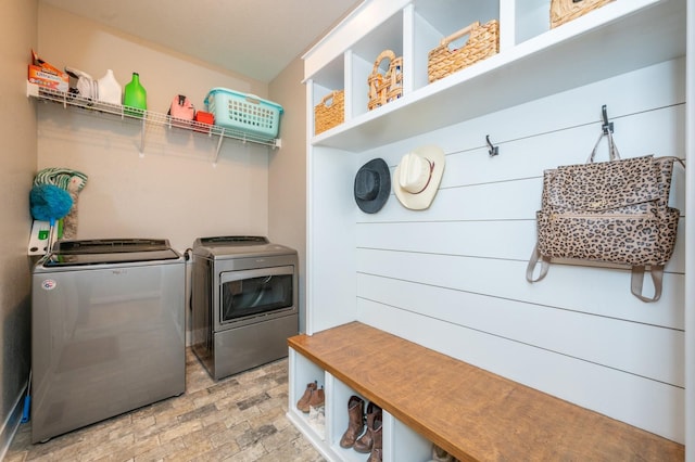 laundry area featuring laundry area, brick floor, and washing machine and clothes dryer