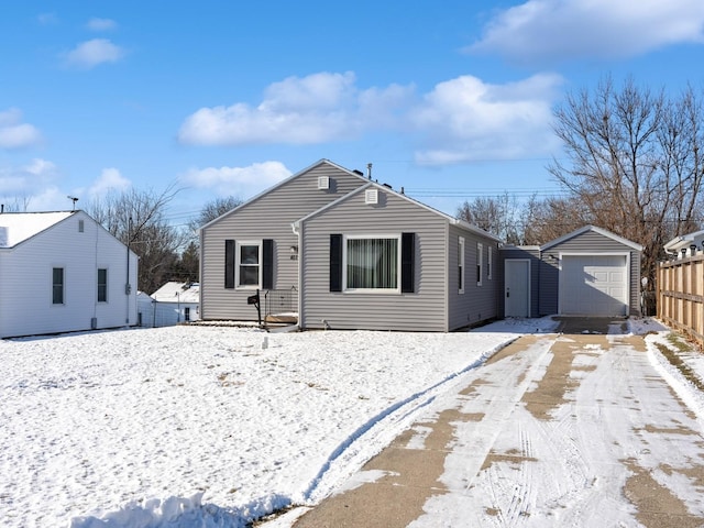 view of front of property featuring an outdoor structure and a garage