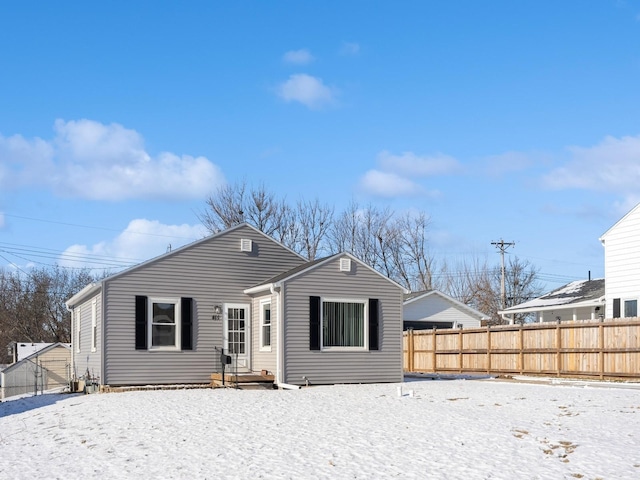 view of snow covered rear of property