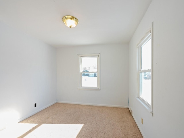 carpeted spare room with plenty of natural light