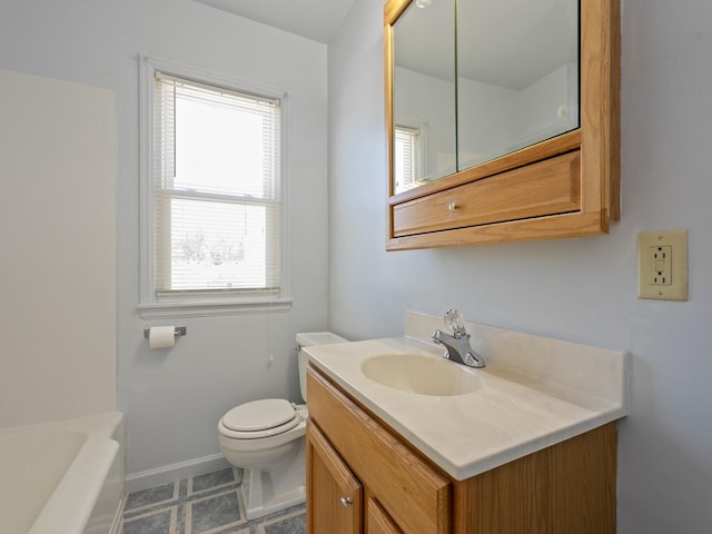 bathroom featuring vanity, toilet, and plenty of natural light