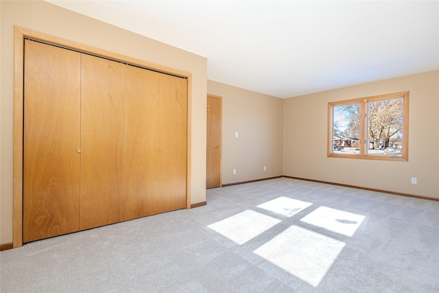 unfurnished bedroom with light colored carpet