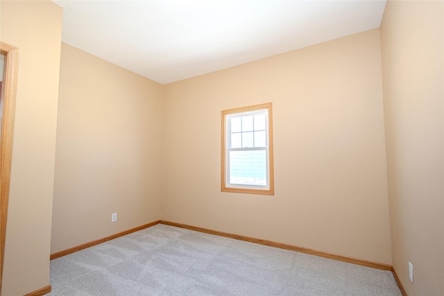 unfurnished room featuring light colored carpet