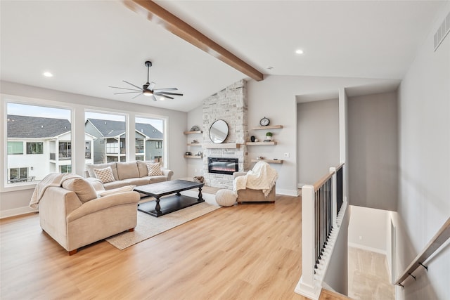 living room featuring lofted ceiling with beams, light hardwood / wood-style flooring, plenty of natural light, and ceiling fan