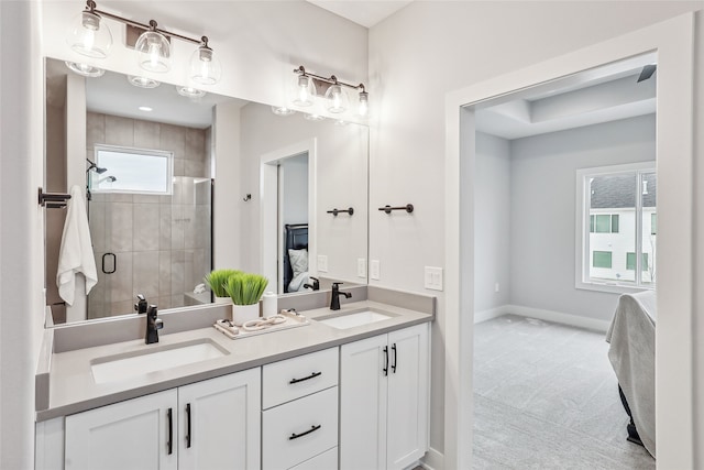 bathroom with vanity and a shower with door