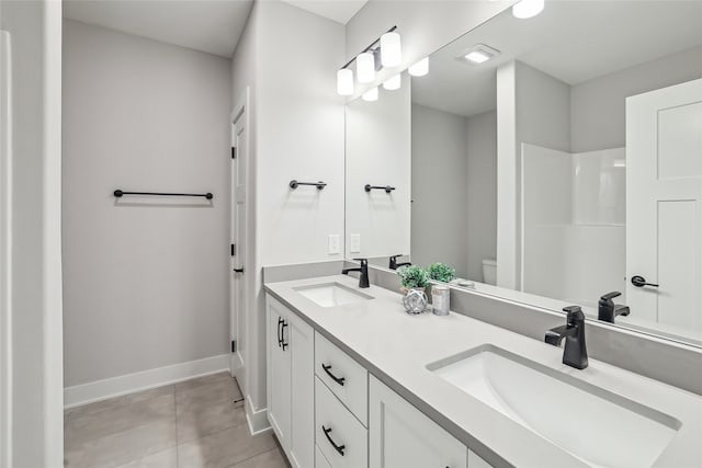 bathroom with tile patterned floors, vanity, and toilet