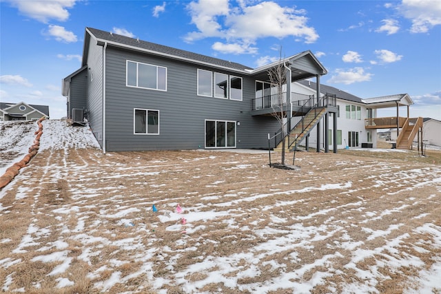 view of snow covered rear of property