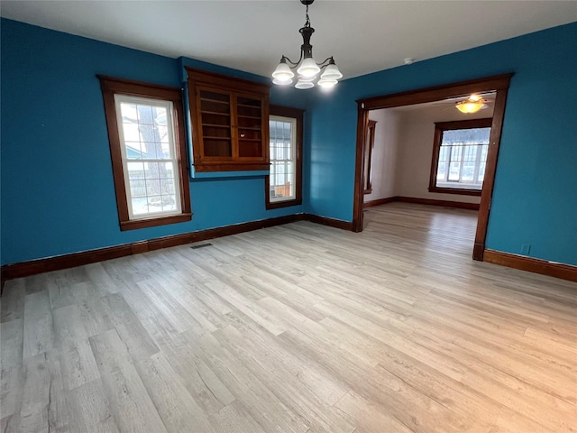 interior space featuring light hardwood / wood-style floors and a chandelier