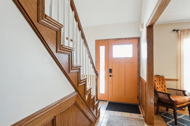 foyer with a healthy amount of sunlight and light tile patterned flooring