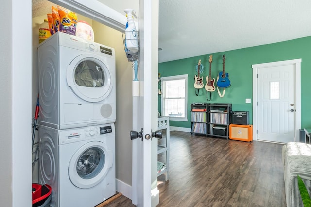 laundry room with stacked washer / dryer, dark hardwood / wood-style flooring, and a textured ceiling