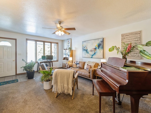 tiled living room with ceiling fan and a textured ceiling