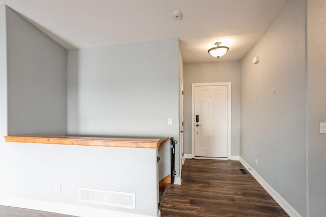 entryway with dark hardwood / wood-style floors