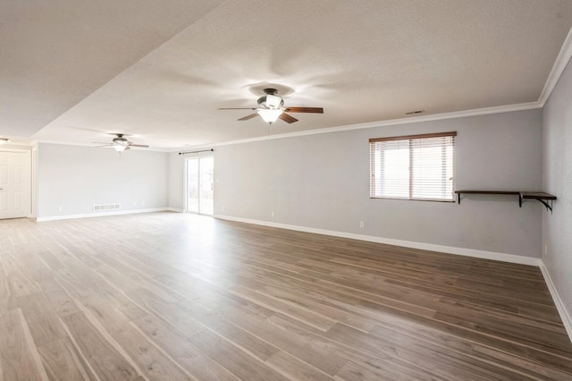 spare room with crown molding, ceiling fan, a textured ceiling, and hardwood / wood-style flooring