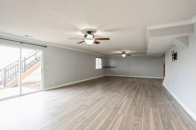 unfurnished room with ceiling fan, light wood-type flooring, ornamental molding, and a wealth of natural light