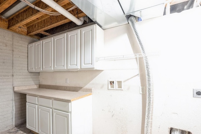 clothes washing area featuring hookup for an electric dryer, washer hookup, and cabinets