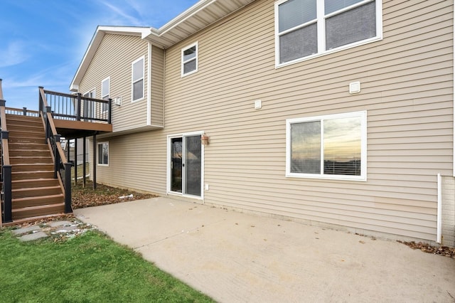 back of house featuring a patio area and a wooden deck