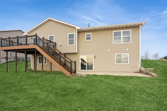 rear view of house featuring a lawn and a wooden deck