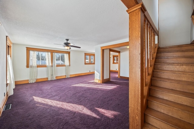 interior space featuring carpet flooring and ceiling fan