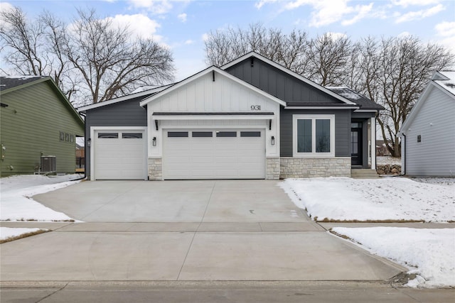 view of front of property featuring a garage and central AC unit