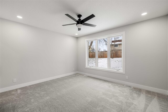 unfurnished room featuring ceiling fan, carpet floors, and a textured ceiling