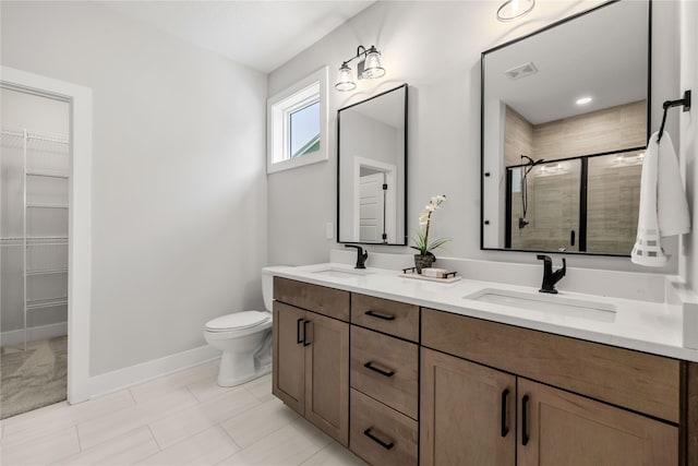 bathroom featuring vanity, toilet, and a shower with door