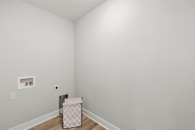 washroom featuring washer hookup, light wood-type flooring, and electric dryer hookup