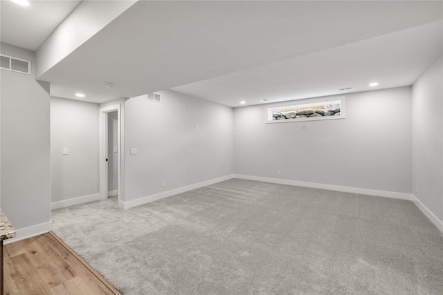 basement featuring light colored carpet