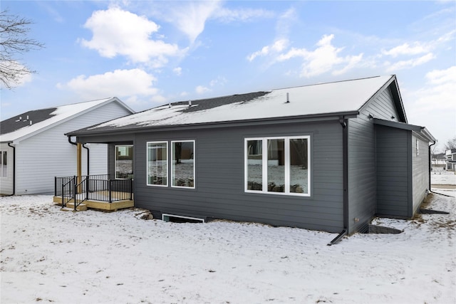 snow covered property with a deck