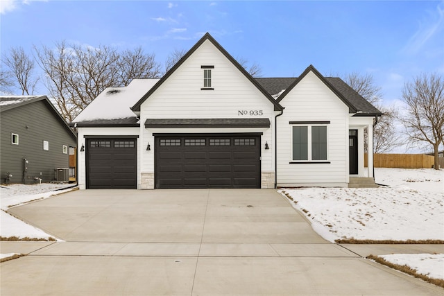 modern farmhouse featuring cooling unit and a garage