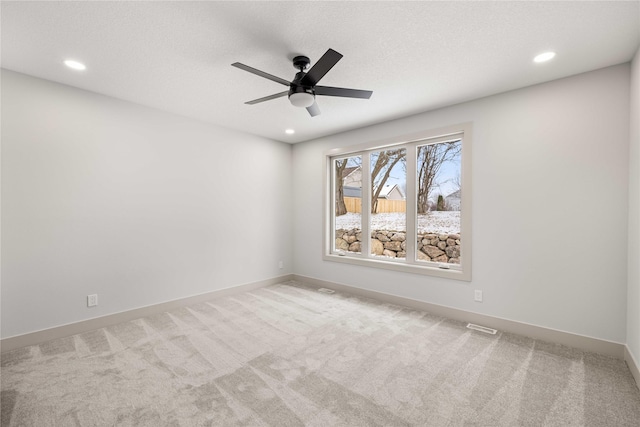 carpeted empty room with ceiling fan