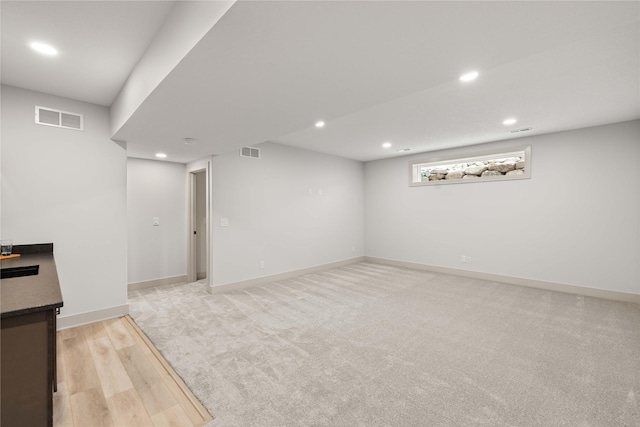 basement featuring light hardwood / wood-style flooring