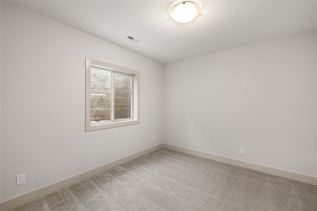 spare room with carpet floors and a textured ceiling