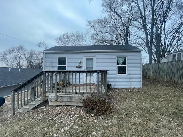 back of property with a wooden deck