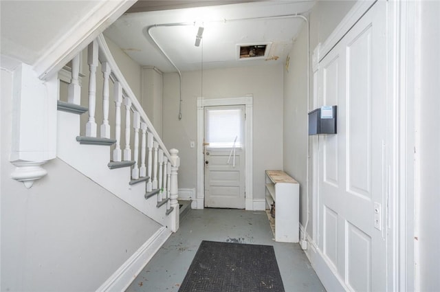 foyer entrance featuring concrete flooring