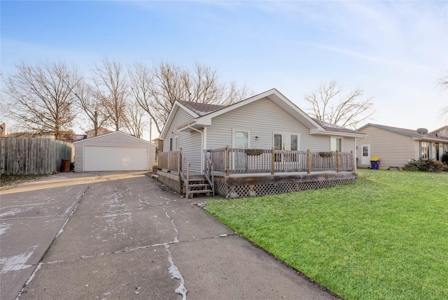 view of front of property with an outbuilding, a garage, a front lawn, and a deck