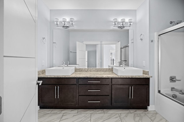 bathroom featuring shower / bath combination with glass door and vanity