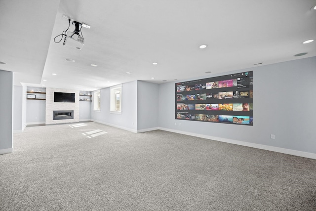 unfurnished living room with carpet flooring, built in features, and a fireplace